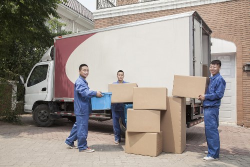 Team member loading items safely into a van during a removals job