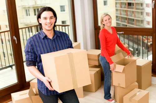 Worker using proper lifting technique while carrying a box