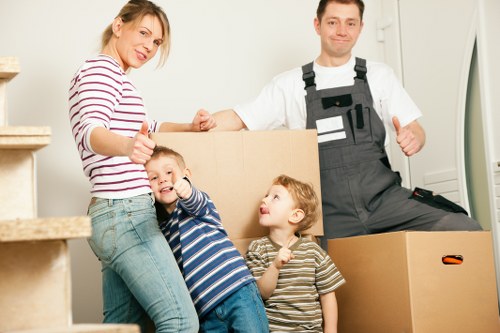 Removal team handling furniture in a typical Enfield property